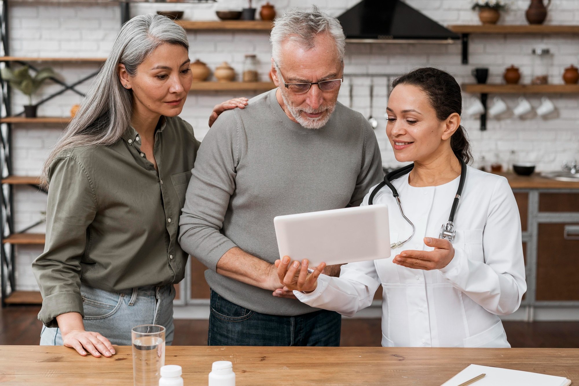 Medicare agent showing tablet to senior couple